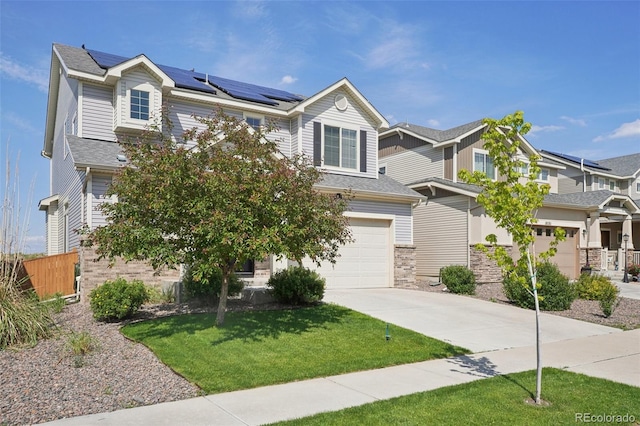 18079 E 108th Pl, Commerce City, CO 80022 - view of front facade with driveway, roof mounted solar panels, an attached garage, and stone siding