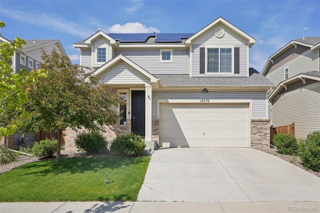 18079 E 108th Pl, Commerce City, CO 80022 - view of front of property with brick siding, solar panels, a garage, a front yard, and concrete driveway