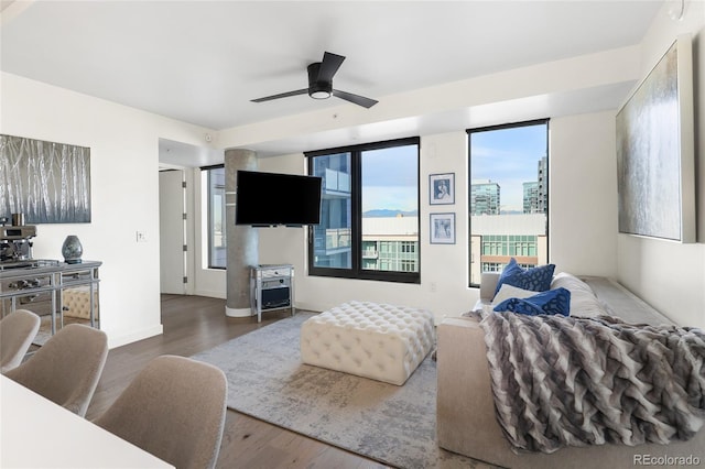 living room featuring ceiling fan and hardwood / wood-style floors