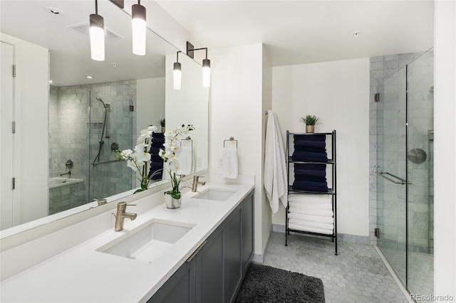 bathroom with an enclosed shower, vanity, and tile patterned floors