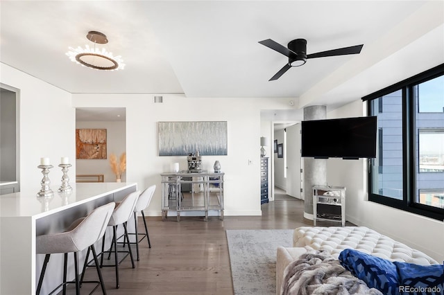 living room featuring dark hardwood / wood-style flooring and ceiling fan