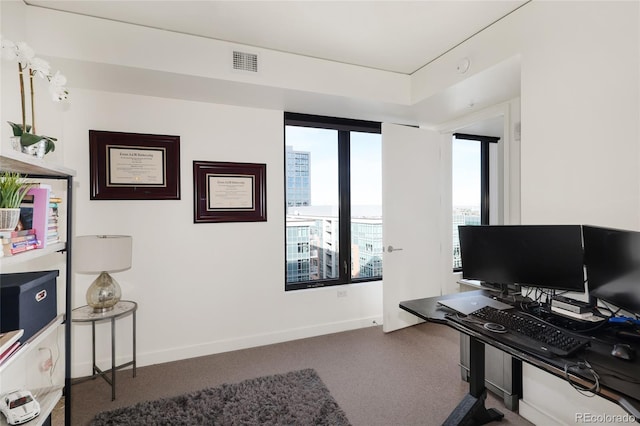 home office featuring dark carpet and a wealth of natural light