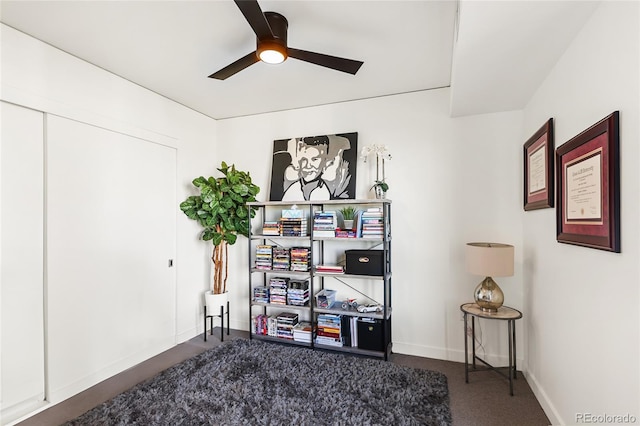 interior space featuring ceiling fan and carpet flooring