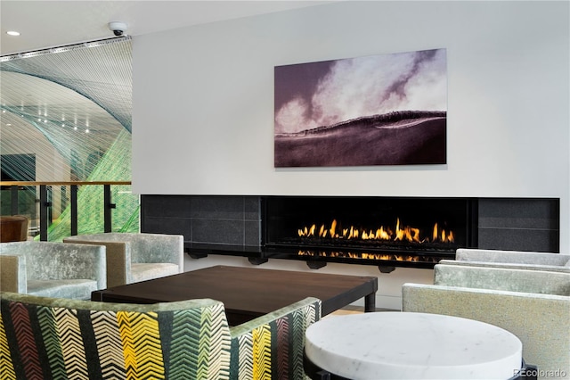 living room featuring a tile fireplace