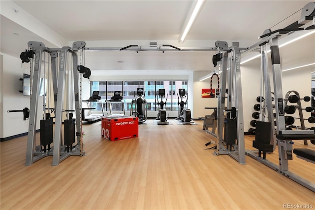 workout area with hardwood / wood-style floors