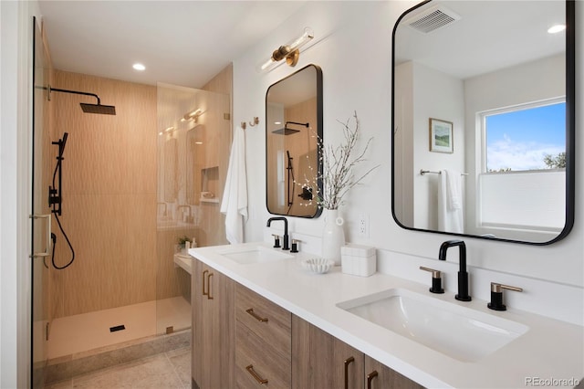 2450 S Cherokee St, Denver, CO 80223 - full bathroom with a walk in shower, double vanity, recessed lighting, and tile patterned floors
