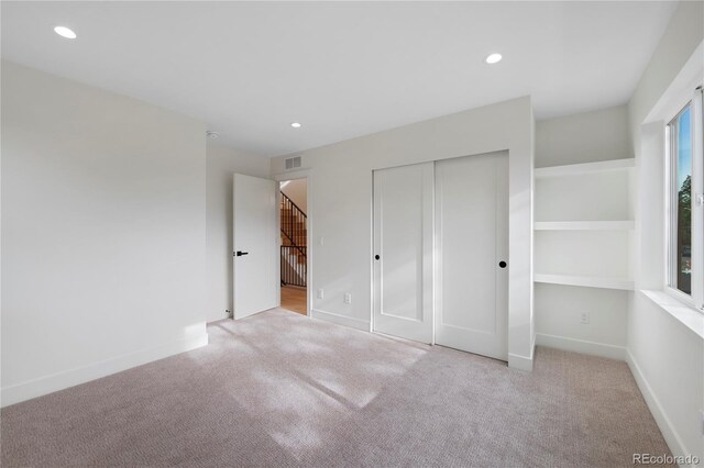 2450 S Cherokee St, Denver, CO 80223 - unfurnished bedroom with carpet flooring, recessed lighting, a closet, and baseboards