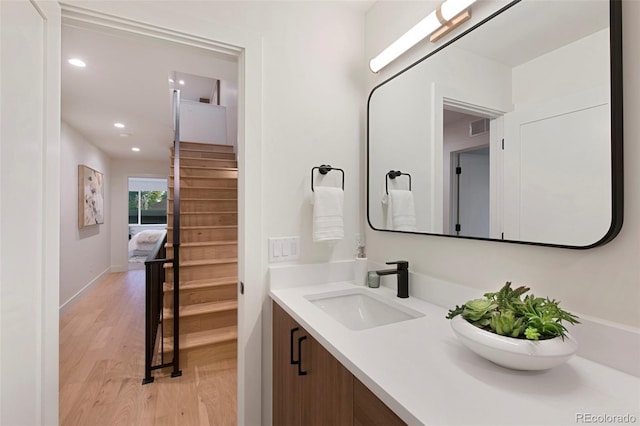 2450 S Cherokee St, Denver, CO 80223 - bathroom with wood finished floors, vanity, and recessed lighting