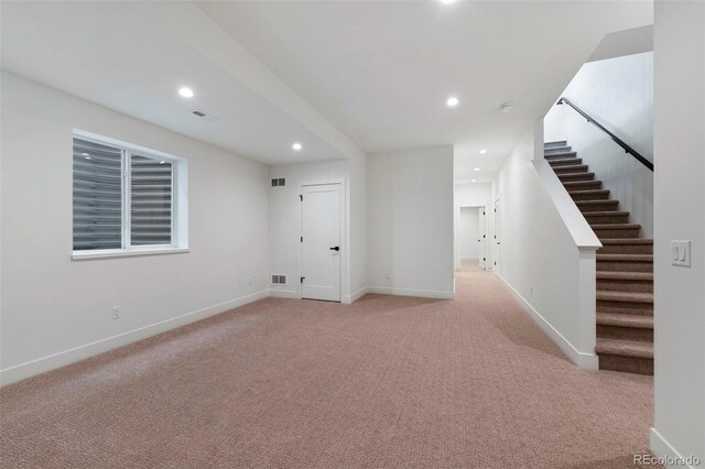 2450 S Cherokee St, Denver, CO 80223 - basement with recessed lighting, light carpet, baseboards, and stairway