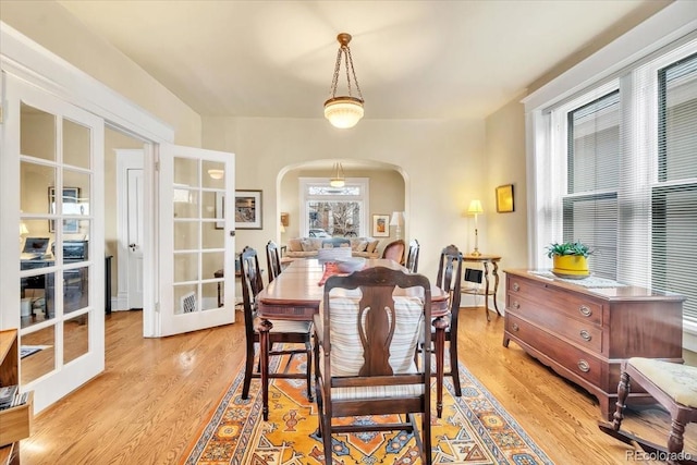 dining room with french doors and light wood-type flooring