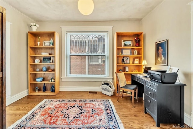 office area featuring hardwood / wood-style flooring and ornamental molding