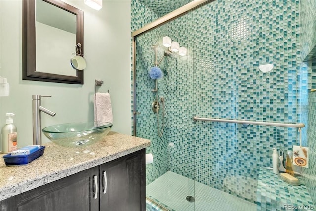 bathroom featuring vanity and an enclosed shower