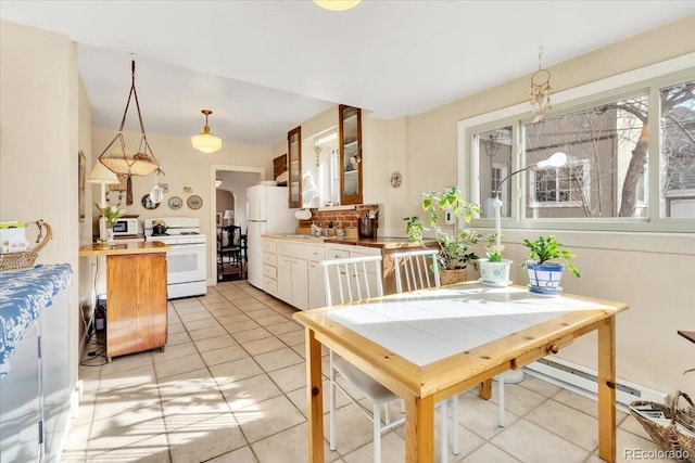 tiled dining area featuring sink