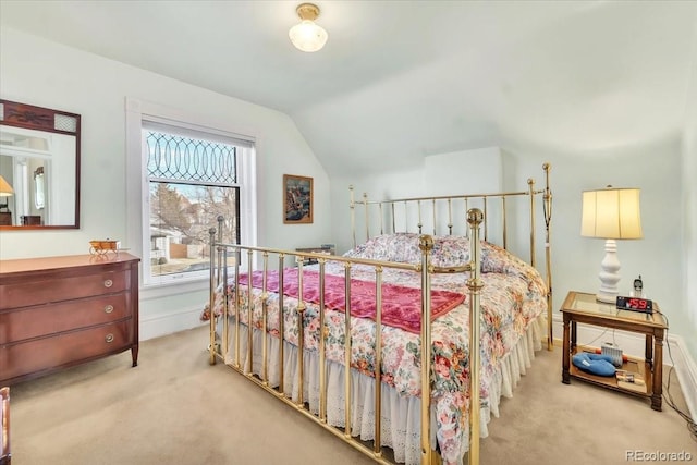 carpeted bedroom with vaulted ceiling