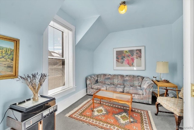 carpeted living room featuring lofted ceiling