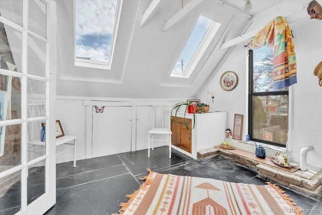 interior space with vaulted ceiling with skylight