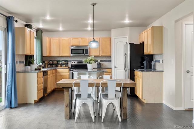 4626 Dancing Rain Way, Colorado Springs, CO 80911 - kitchen featuring stainless steel appliances, a kitchen island, and tasteful backsplash