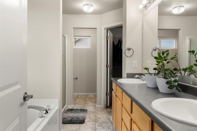 4626 Dancing Rain Way, Colorado Springs, CO 80911 - full bath featuring a shower stall, double vanity, a garden tub, and a spacious closet