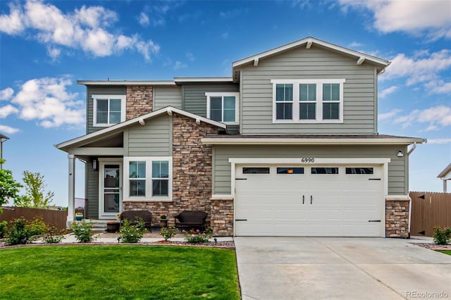 6990 E 132nd Pl, Thornton, CO 80602 - view of front of house featuring stone siding, a garage, concrete driveway, and entry steps