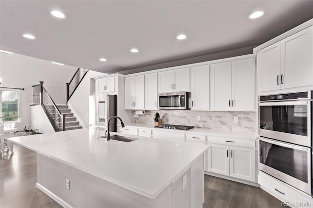 6990 E 132nd Pl, Thornton, CO 80602 - kitchen featuring stainless steel appliances, dark wood-style floors, backsplash, white cabinets, and recessed lighting