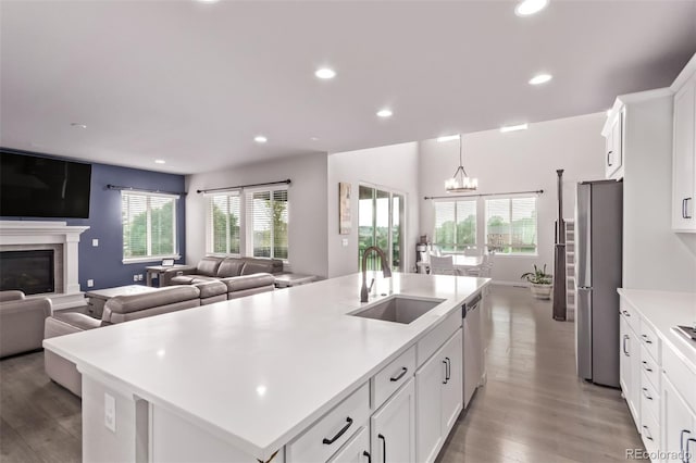 6990 E 132nd Pl, Thornton, CO 80602 - kitchen with appliances with stainless steel finishes, open floor plan, light wood finished floors, and recessed lighting