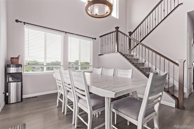 6990 E 132nd Pl, Thornton, CO 80602 - dining area featuring wood finished floors, a chandelier, and stairs