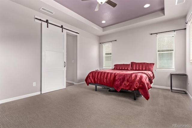 6990 E 132nd Pl, Thornton, CO 80602 - bedroom with a barn door, carpet floors, recessed lighting, a tray ceiling, and a ceiling fan