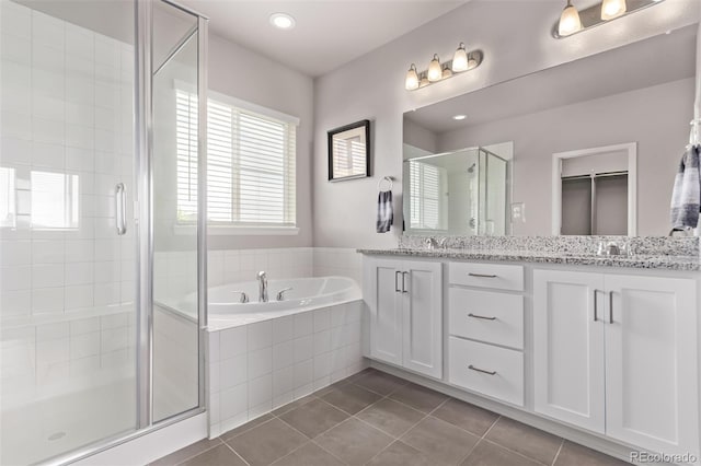 6990 E 132nd Pl, Thornton, CO 80602 - full bath with a stall shower, double vanity, tile patterned flooring, a garden tub, and recessed lighting