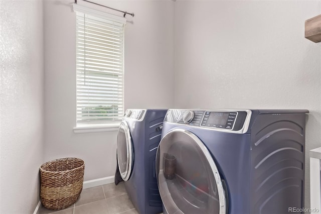 6990 E 132nd Pl, Thornton, CO 80602 - washroom featuring washing machine and dryer and light tile patterned floors