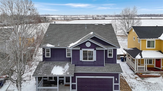 view of front of property featuring a garage and a porch