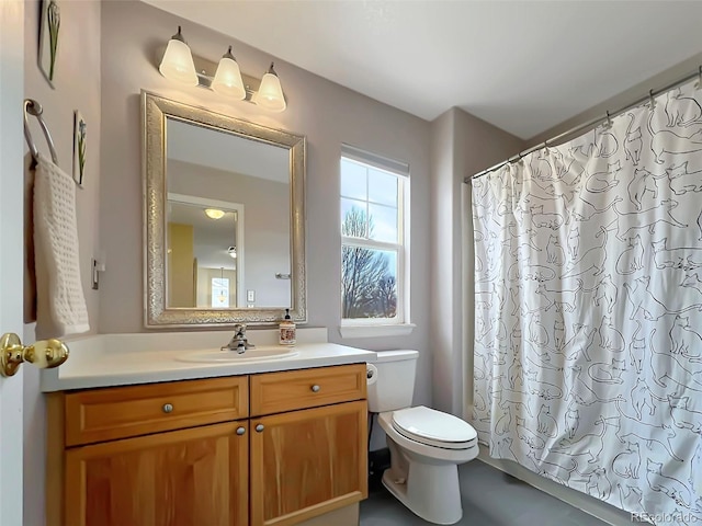 bathroom with toilet, curtained shower, and vanity