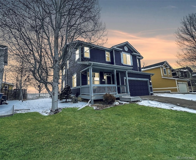 view of front of home with a garage, driveway, a porch, and a lawn