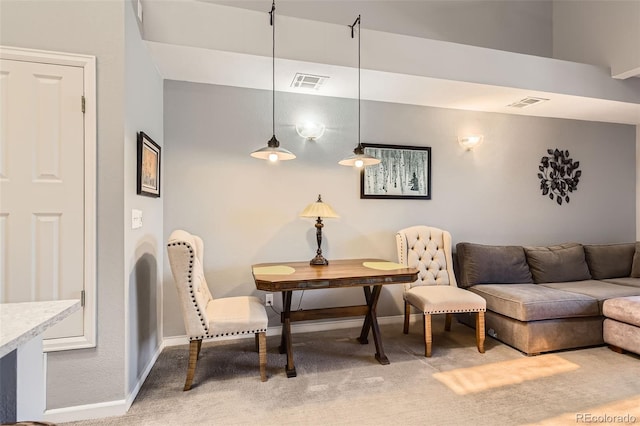 living area featuring visible vents, baseboards, and light colored carpet