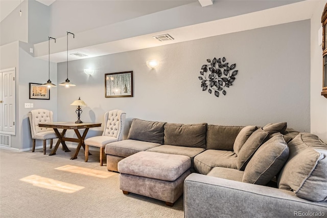 carpeted living room featuring baseboards and visible vents