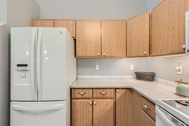 kitchen featuring white fridge with ice dispenser and light stone countertops