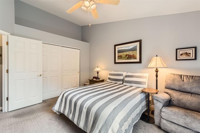 carpeted bedroom with ceiling fan, lofted ceiling, and a closet