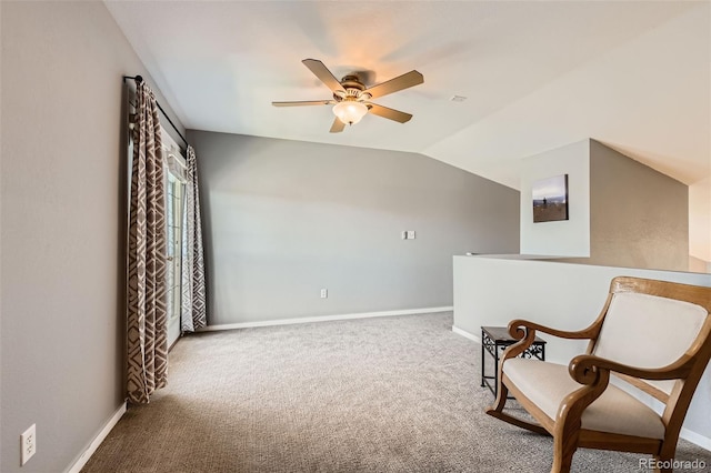 living area featuring a ceiling fan, baseboards, vaulted ceiling, and carpet