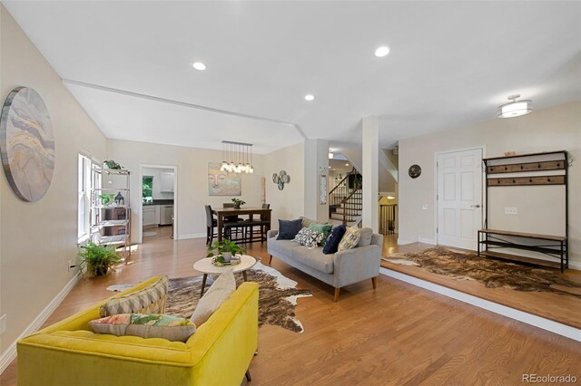 7773 Gunsight Pass, Littleton, CO 80127 - living area with stairs, wood finished floors, baseboards, and recessed lighting