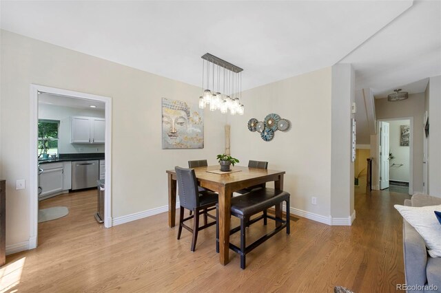 7773 Gunsight Pass, Littleton, CO 80127 - dining space with light wood-style flooring and baseboards