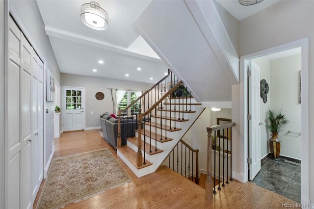 7773 Gunsight Pass, Littleton, CO 80127 - entryway featuring baseboards, wood finished floors, recessed lighting, and stairs