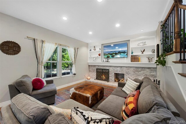 7773 Gunsight Pass, Littleton, CO 80127 - living room featuring baseboards, a fireplace, and recessed lighting