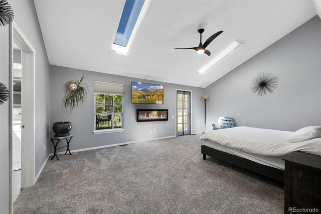7773 Gunsight Pass, Littleton, CO 80127 - carpeted bedroom featuring vaulted ceiling, a skylight, multiple windows, baseboards, and ceiling fan