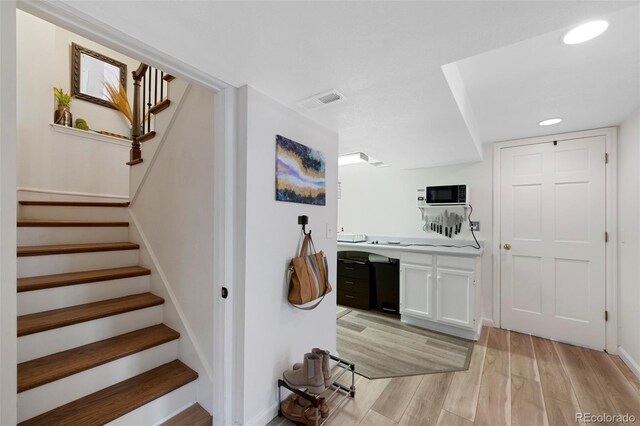 7773 Gunsight Pass, Littleton, CO 80127 - stairway featuring wood finished floors, baseboards, and recessed lighting