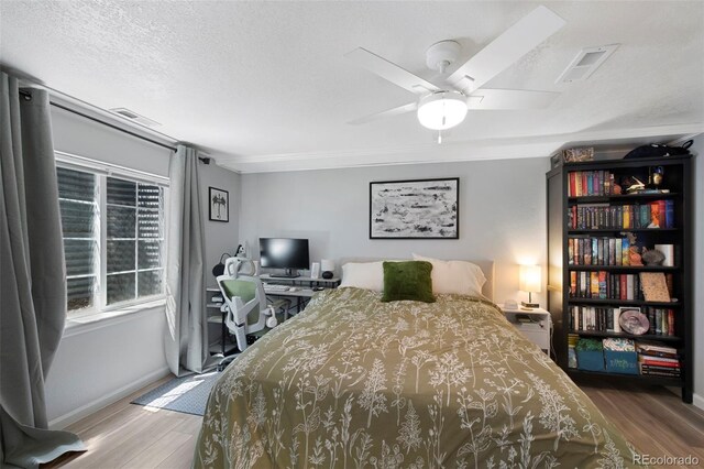 7773 Gunsight Pass, Littleton, CO 80127 - bedroom with wood finished floors, baseboards, and a ceiling fan