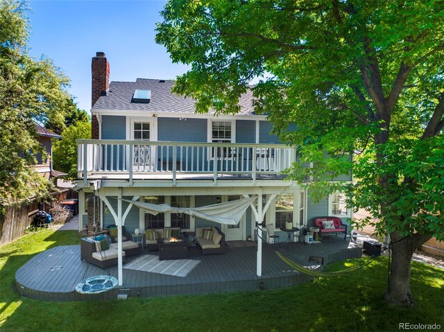 7773 Gunsight Pass, Littleton, CO 80127 - back of property featuring an outdoor living space, a wooden deck, a chimney, a yard, and a balcony