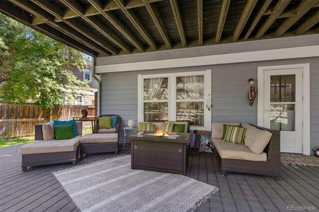 7773 Gunsight Pass, Littleton, CO 80127 - wooden deck featuring an outdoor living space with a fire pit