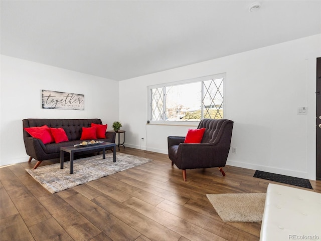 living room featuring baseboards and wood finished floors