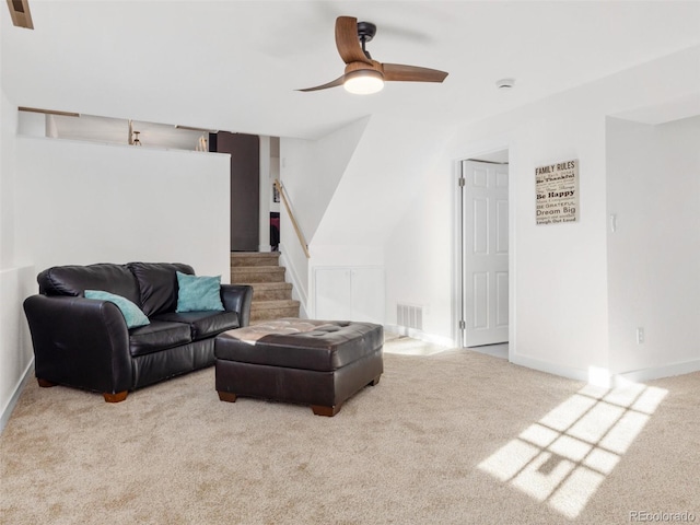 carpeted living area featuring visible vents, a ceiling fan, stairs, and baseboards