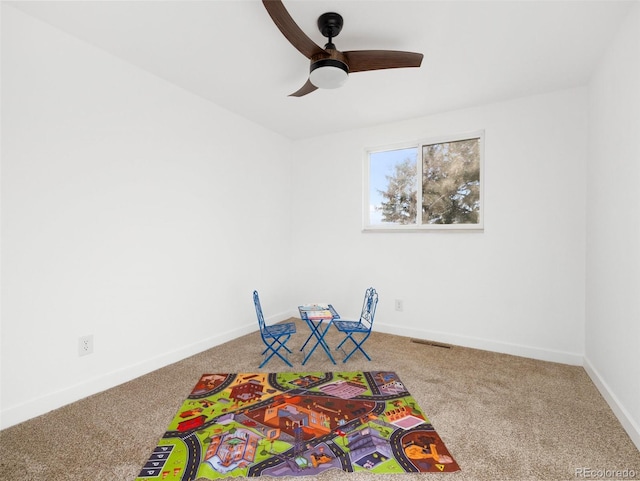 playroom with carpet flooring, visible vents, a ceiling fan, and baseboards