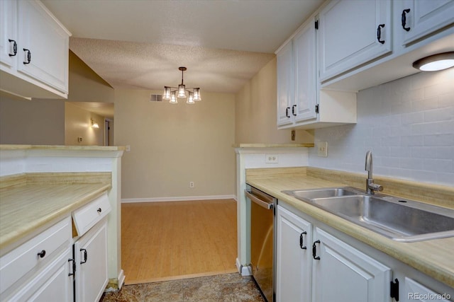 kitchen featuring stainless steel dishwasher, light countertops, white cabinetry, and a sink